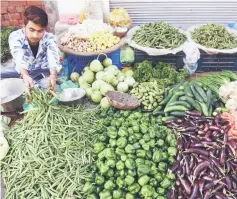  ?? — AFP photo ?? File photo shows an Indian vendor selling vegetables at a roadside stall in Amritsar.