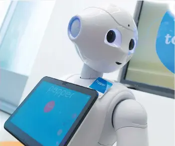  ?? GAVIN YOUNG ?? ATB Financial introduced a $20,000 robot called Pepper, which engages with customers at some branches in Calgary. Pepper can’t do many tasks but it is testing the waters for future automation.