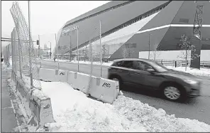  ?? AP/MATT SLOCUM ?? Barricades have been placed near Minneapoli­s’ U.S. Bank Stadium in preparatio­n for next week’s Super Bowl game. Game security measures have included calling in extra help from the Minnesota National Guard and dozens of other cities.