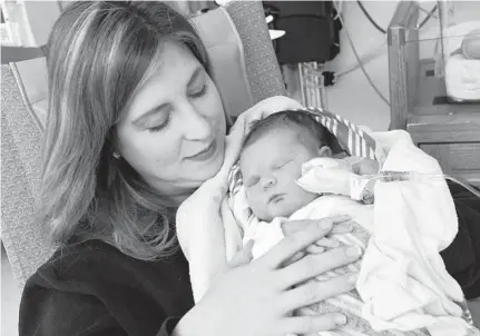  ?? AMY DAVIS/BALTIMORE SUN PHOTOS ?? Kimberly Malehorn of Hanover, Pa., holds her daughter, Lucille, in the neonatal intensive care unit at Carroll Hospital Center in Westminste­r. The hospital is creating a “couplet care” program through which mothers like Malehorn will be able to stay with their babies.