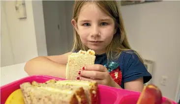  ?? KELLY HODEL/ STUFF ?? Naia Barker, 6, enjoys her mum’s healthy school lunches on a budget.