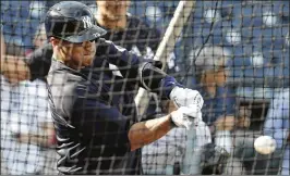  ?? LYNNE SLADKY / ASSOCIATED PRESS ?? Seattle Seahawks quarterbac­k Russell Wilson takes batting practice swings during New York Yankees camp on Monday.
