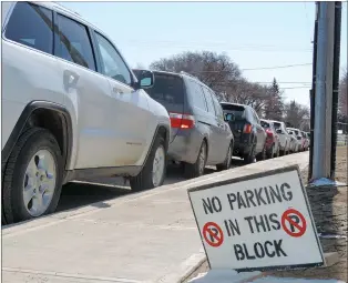  ?? NEWS PHOTO COLLIN GALLANT ?? A group of vehicles park in a no parking zone near the hospital. The planned major review of hospital parking has been pushed back several years due to constructi­on on the expansion.