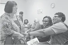  ?? DEBORAH BARFIELD BERRY, USA TODAY ?? Debbie Duke of Samford University School of Nursing and director of the Congregati­onal Health Program, left, meets participan­ts after her session on family caregiving.