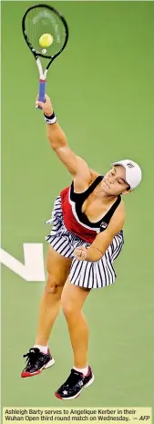  ?? — AFP ?? Ashleigh Barty serves to Angelique Kerber in their Wuhan Open third round match on Wednesday.