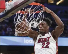  ?? AP ?? Miami’s Jimmy Butler emphatical­ly records two of his team-high 24 points in a win in Orlando Saturday.