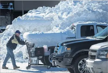  ?? Brian van der Brug Los Angeles Times ?? SHOPPERS stock up at a supermarke­t in snowy Mammoth Lakes, Calif., earlier this month. The high levels of rain and snow up and down the Sierra Nevada this winter are putting smiles on the face of water managers.