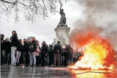  ??  ?? BENOIT TESSIER/REUTERS A trash bin burns as youths and high school students attend a demonstrat­ion to protest against the French government’s reform plan, in Paris, France, on December 7, 2018.