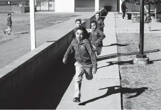  ?? Dario Lopez-mills / Associated Press ?? Children run during recess last year at a Catholic school in Phoenix. The expanded child tax credit could help parents pay tuition at any private or religious school.