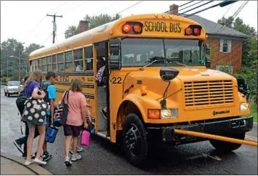  ?? News-herald photos — DEBBY HIGH ?? BACK TO SCHOOL ... Tuesday marked the start of the 201213 school year in Pennridge, with students across the district heading back to school. ABOVE: Students climb on the bus Tuesday. LEFT: Rebecca and Steven Patzer walk their son, Sean, in for his...