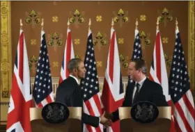  ?? BEN STANSALL — POOL VIA AP ?? President Barack Obama and Britain’s Prime Minister David Cameron attend a news conference Friday at the Foreign and Commonweal­th Office in central London following their talks at Downing Street. Obama stepped into Britain’s debate about EU membership...