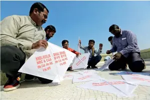  ?? AP ?? Gujarat residents get ready to fly kites with messages protesting against a new citizenshi­p law during the kite festival in Ahmedabad on Tuesday. —