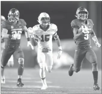  ?? NWA Democrat-Gazette/ANDY SHUPE ?? Arkansas kick returner De'Vion Warrren (9) heads to the end zone ahead of Auburn's Jordyn Peters (15) as he returns a kickoff 100 yards for a touchdown Saturday at Razorback Stadium in Fayettevil­le. Visit nwadg.com/photos for more photos from the game.