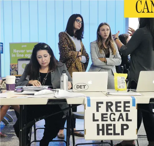  ?? STEPHEN CARR / THE ORANGE COUNTY REGISTER VIA THE ASSOCIATED PRESS ?? Immigratio­n lawyer Maggie Castillo, left, of the American Immigrants Lawyers Associatio­n, offered her services at Los Angeles Internatio­nal Airport after a scaled-back version of U. S. President Donald Trump’s travel ban took effect.