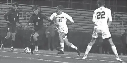  ?? BRANDON BROWN ?? Oyster River’s Max Scopel (21) and Lebanon’s Conner Chinn battle for ball control during Tuesday’s 1-0 win for Lebanon in the Division II semifinals.