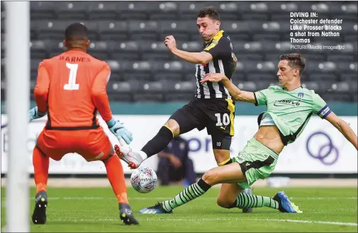  ?? PICTURE: Media Images Ltd ?? DIVING IN: Colchester defender Luke Prosser blocks a shot from Nathan Thomas