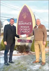  ?? Photo submitted ?? Ken Kane, Catholic Foundation of Northwest Pennsylvan­ia board secretary, presents a grant check to Father Kevin Holland, Pastor of Saint Boniface Parish.