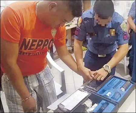  ?? PNP REGIONAL OFFICE 3 PHOTOS ?? Adell Roll Milan, one of the suspects in the killing of Fr. Richmond Nilo, undergoes booking procedures at the Nueva Ecija Provincial Police Office in Cabanatuan City yesterday. Insets show the police sketches of Milan (left) and two other suspects.