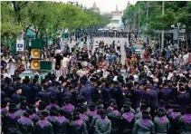  ?? - Reuters ?? PROTEST: Police officers stand guard during a protest to demand that the military government hold a general election in Bangkok, Thailand.