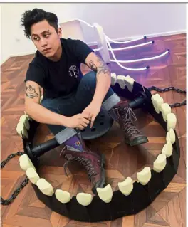  ?? — KaMaruL arIFFIN/The star ?? Gomes sitting inside his work Gap Space (steel, fiberglass resin, stool top, chain, 2019).