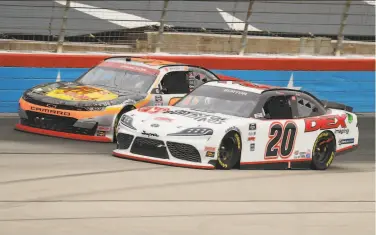  ?? Richard W. Rodriguez / Associated Press ?? Harrison Burton ( 20) pulls ahead of Noah Gregson as they battle out of Turn 4 down the front stretch.