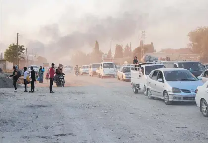  ?? Photo / AP ?? Syrians flee the town of Ras al Ayn after shelling by Turkish forces yesterday.