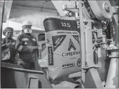  ?? PHOTO: SUPPLIED ?? Cement bags go through a sealing machine in Rwanda. The writer says South African producers need to withstand the headwinds of a shrinking local market.