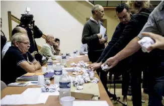  ??  ?? Pendant un conseil municipal, des villageois mécontents donnent à la maire des boulettes de papier froissé, « symboles du mépris de la population ».