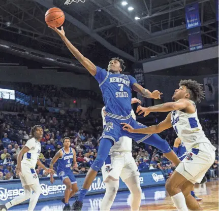  ?? PHOTOS BY BRETT ROJO/USA TODAY SPORTS ?? Tigers forward Nae'qwan Tomlin, left, goes up for a shot past Tulsa guard PJ Haggerty, right, during the second half at Reynolds Center on Tulsa, Okla., on Thursday. The Tigers won the game 78-75.
