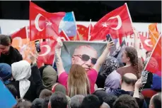  ?? — Reuters ?? Supporters of Turkish President Tayyip Erdogan wait for his address following early exit poll results for the second round of the presidenti­al election in Istanbul, Turkiye.