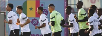  ?? ?? Senegal players jog during a training session at Duhail Handball Sports Hall in Doha yesterday.