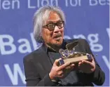  ?? (Alessandro Bianchi/Reuters) ?? DIRECTOR LAV DIAZ holds the Golden Lion prize for the movie ‘The Woman Who Left’ at the 73rd Venice Film Festival.