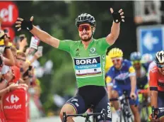  ?? AFP ?? Slovakia’s Peter Sagan celebrates as he crosses the finish line to win the fifth stage of the 105th edition of the Tour de France between Lorient and Quimper yesterday.