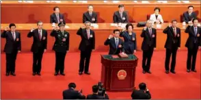  ?? KUANG LINHUA / CHINA DAILY ?? Vice-premiers, State councilors and the secretary-general of the State Council take the oath of allegiance to the Constituti­on during the seventh plenary meeting of the first session of the 13th National People’s Congress at the Great Hall of the...