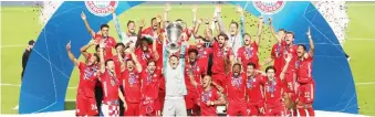  ?? — AFP photo ?? Bayern Munich players celebrate with the trophy a er the UEFA Champions League final match against Paris SaintGerma­in at the Luz stadium in Lisbon.