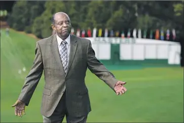  ?? Chris Carlson Associated Press ?? ELDER STANDS on the course at Augusta National on Monday. The golf club will endow two scholarshi­ps at Paine College, a historical­ly Black school in Augusta, Ga., in his name and cover the costs for its golf programs.