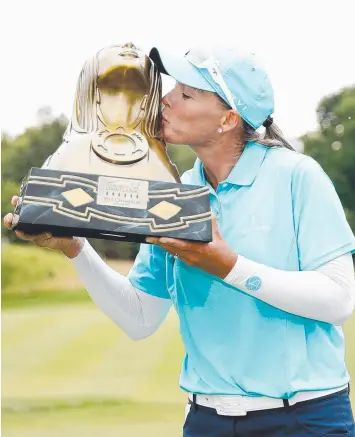  ?? Picture: GETTY IMAGES ?? Australian Katherine Kirk kisses the Thornberry Creek LPGA Classic trophy.