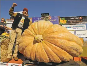  ?? Ben Margot / Associated Press 2019 ?? Leonardo Urena of Napa learns his pumpkin weighed in at 2,175 pounds, a new California weight record, at last year’s pumpkin contest in Half Moon Bay.