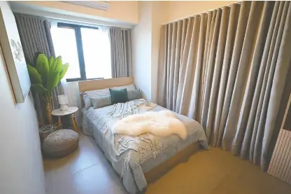  ?? ?? The model unit at Madrid shows a lovely bedroom and living space fit for those who prioritize flexibilit­y and function.
