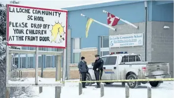  ?? THE CANADIAN PRESS FILES ?? RCMP officers stand outside the La Loche Community School on Jan. 25, 2016, after a teenaged shooter killed two and injured seven. The shooter is set to be sentenced on Friday.