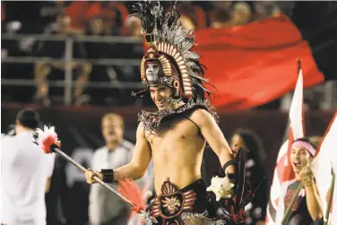  ?? Hayne Palmour IV / TNS 2017 ?? San Diego State mascot Kevin Hoffert runs ahead of the Aztecs football team before a game against Fresno State in San Diego last October. The university will create a more culturally sensitive version of its mascot.