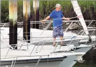  ?? Christian Abraham / Hearst Connecticu­t Media ?? Bruce Johnson ties down his sails in anticipati­on of Hurricane Henri at Halloween Yacht Club in Stamford on Friday. Henri is expected to hit Connecticu­t over the weekend causing coastal flooding and wind gusts up to 60 mph.