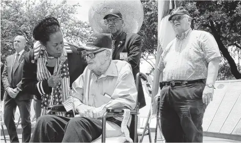  ?? Elizabeth Conley / Staff photograph­er ?? World War II veteran Joseph M. Burch, 93, talks to U.S. Rep. Sheila Jackson Lee during the annual Memorial Day event at the Houston Heights WWII Memorial Plaza on Monday. She represents the area and helped organize the event. The congresswo­man urged those in the audience not to leave returning veterans behind. “Let us say thank you by checking on you,” she said.