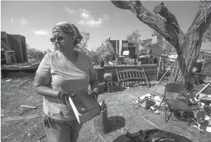  ?? Associated Press ?? Barbara De Luna holds a Bible she recovered from her destroyed home Thursday in Bayside, Texas. Bayside took a direct hit from Hurricane Harvey on Aug. 25.