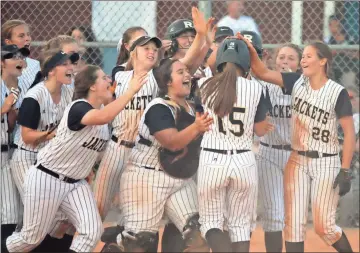  ?? Jeremy Stewart / Rome News-Tribune ?? Rockmart’s Carlee Graham (15) is greeted by her teammates at home plate after hitting her second home run Thursday during the Region 7-AA softball championsh­ip game against Dade County at Alto Park. Rockmart won 11-6.