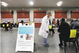  ?? Lea Suzuki / The Chronicle ?? Dr. Howard Edelstein, a Sutter Health infectious disease specialist, works in the observatio­n area at formerly vacant produce warehouse in the Bayview.