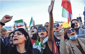  ?? JULIEN DE ROSA/AFP VIA GETTY IMAGES ?? Demonstrat­ors rally in Paris on Sunday in support of Iranian protests over the September death of Mahsa Amini in Iran.