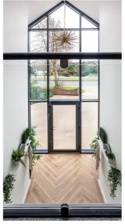  ??  ?? Right: The double height window at the front of the house ensures that the property is flooded with natural light throughout