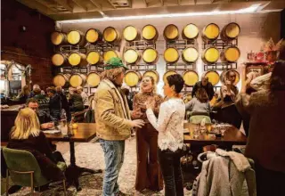  ?? Brian L. Frank/Special to The Chronicle ?? Visitors play bocce at Anaba Wines in Sonoma, top; above, Gundlach Bundschu owner Jeff Bundschu greets guests during happy hour; at left, Anaba Wines’ outdoor activities; bottom, Carlos Reyes chats with visitors at Anaba.