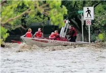  ?? GAVIN YOUNG/ POSTMEDIA NEWS FILES ?? ONE YEAR AGO: The Calgary Fire Department rescues a family from their flooded apartment on June 21, 2013.